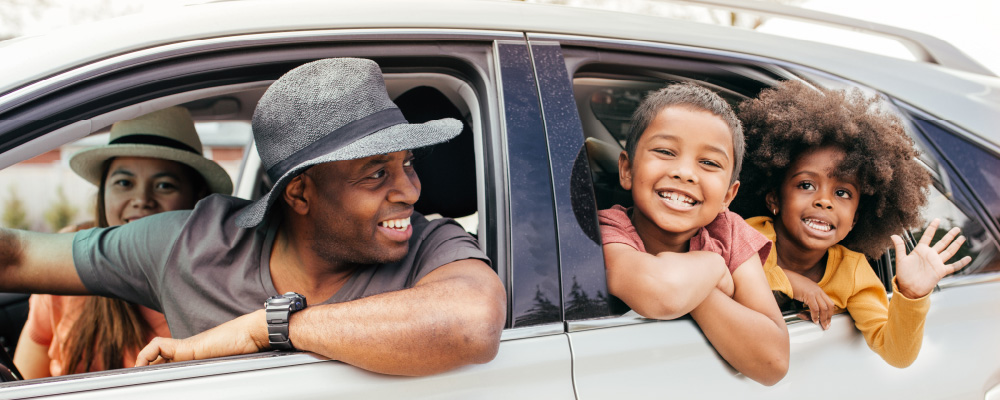 A smiling family in a car